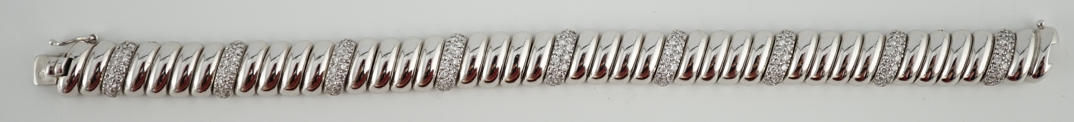 A modern Cartier 18ct white gold and diamond cluster set bracelet